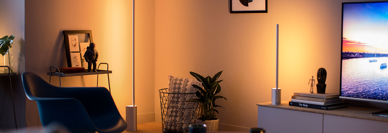 Wohnzimmer mit smarter Philips Hue Beleuchtung in warmen Licht