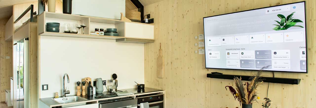 Küche mit Fernseher an Wand und geöffnetem Samsung SmartThings Dashboard